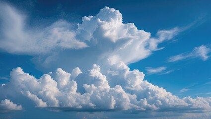 Wall Mural - cumulus clouds forming dynamic shapes against a bright blue sky during daytime with some wispy cloud