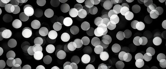 Wall Mural - Abstract blurred lights in grayscale defocused bokeh background on dark surface for design and art concepts