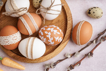 Wall Mural - Wooden plate with decorated Easter eggs, gift boxes and willow branches on white background