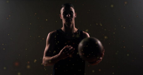 Poster - Image of moving spots over caucasian male basketball player holding basketball