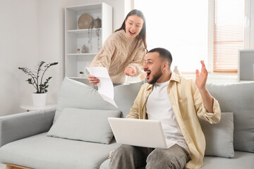 Wall Mural - Happy young woman with refund form and her husband at home