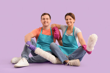 Poster - Young couple with pp-dusters sitting on lilac background