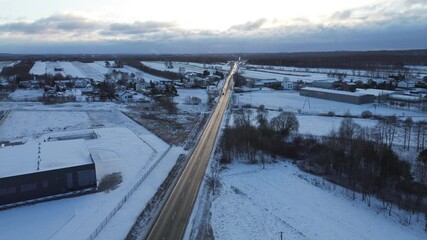 Canvas Print - Aerial perspective of snow-covered rural road