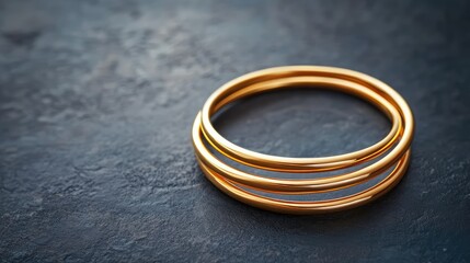 Poster - Thin minimalist gold rings stacked together, placed on a modern dark gray background. No text, no people.