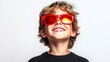 © Nataliia_Trushchenko - Young boy wearing red sunglasses is smiling. Concept of happiness and playfulness