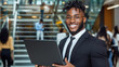 © Irina B - Professional young man with laptop in modern business setting, ideal for corporate presentations or office concept design