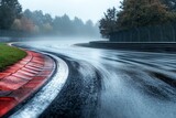 Rain-soaked track at a motorsport circuit during a foggy autumn day
