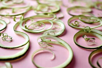 Aufkleber - Cucumber Peel Spirals on a Pastel Backdrop Highlight Minimalist Artistry