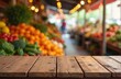 © miss irine - Rustic wooden tabletop against blurred market background. Fresh colorful produce includes fruits, vegetables. Empty space, natural texture, brown grain on wood. Farmers market stall ideal for product