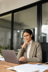 vertical portrait middle eastern woman using computer technology app for work online.focused profess
