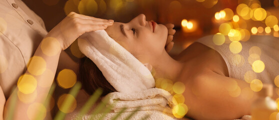 Wall Mural - Young woman receiving massage in spa salon, bokeh effect. Banner design