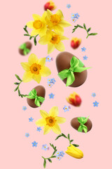 Sticker - Chocolate eggs and beautiful spring flowers in air on pink background