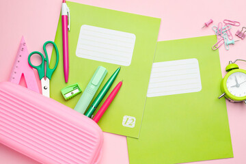 Wall Mural - Copybooks and other school stationery on pink background, flat lay