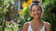 © BROTHER - Smiling young female in sunlit garden with greenery and flowers