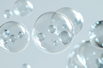 Poster - Transparent spheres containing smaller spheres, floating in a light gray background, creating a sense of depth and serenity.