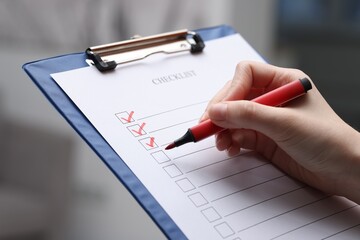 Wall Mural - Woman filling Checklist on blurred background, closeup