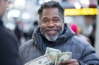 © Milos - A cheerful man holds stacks of money while smiling brightly, captured amidst a bustling street scene, reflecting positivity and human connection in urban life.