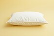 © MrHamster - A fluffy white pillow resting on a warm yellow background