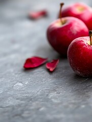 Aufkleber - Three Fresh Red Apples with Petals on Slate Surface Creating a Rustic Kitchen Scene : Generative AI