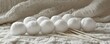 © Svitlana - White yarn balls and knitting needles on soft fabric background