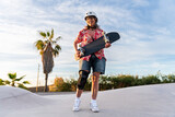 Beautiful active senior woman skateboarding at skate city park - Mature adult female skateboarder having fun, concepts about elderly, modern lifestyle and green mobility