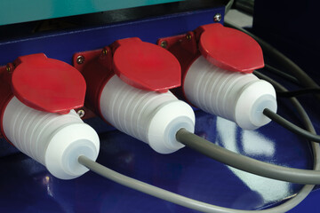 Poster - Three white and red electrical plugs are connected to a grey wire. The wires are connected to a device