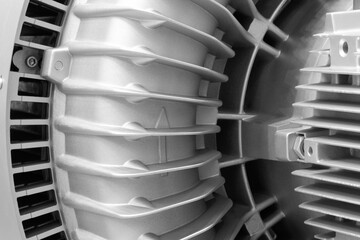 Aufkleber - A close-up of an electric machine with a silver ribbed surface. The machine has many metal parts and is very shiny.