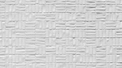 Poster - wall is made of white bricks and has a unique pattern of squares. The bricks are arranged in a way that creates a visually interesting design. The wall appears to be made of cement