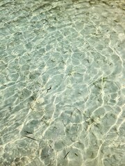 Crystal clear water gently rippling in shallow tropical lagoon