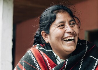 Celebrating heritage portrait of a middle-aged hispanic woman in a vibrant shawl outdoor setting capturing joy and culture