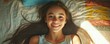 © Влада Яковенко - Smiling young girl lying on bed with sunlit hair in a cozy bedroom setting