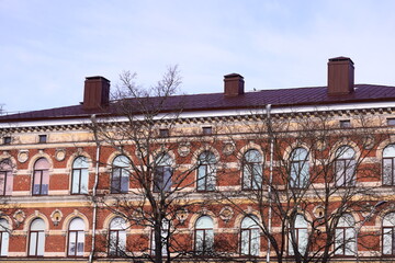 Poster - A large brick building with a clock tower, suitable for use in architectural or cityscape scenes.
