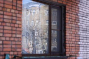 Poster - A reflection of a building is visible through a window, providing a unique perspective.