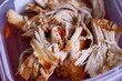 © Fotograf - Container filled with shredded chicken and carrots, perfect for meal prep or pet food.
