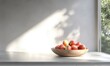 © Sergey - Minimalist kitchen counter with sleek white cabinetry and a wooden fruit bowl filled with fresh apples illuminated by soft natural sunlight creating a clean and modern interior