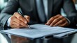 © andi - Businessman signing documents in office
