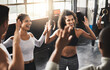 © peopleimages.com - High five, happy and friends in gym for fitness, training and workout target for teamwork goals. Sports, group and men and women celebrate with gesture for exercise, health and performance in class