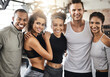 © peopleimages.com - Friends, happy and portrait at gym with people, diversity or hug for training, fitness or health. Group, men and women with embrace, smile and support for solidarity for workout, exercise or wellness