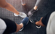 © peopleimages.com - Fitness, group or huddle with shoes at gym in circle for teamwork, workout or unity at indoor health club. Top view, closeup or active people with feet or sneakers for motivation or exercise together