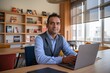 © KANTIC - Calm & Focused Businessman Working on Laptop in Modern Office, Blue Shirt and Vest, Warm Lighting, Bookshelves, Natural Light from Windows, Medium Shot