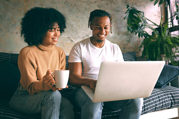 Poster - Coffee, home and couple on sofa with laptop for online shopping, internet and digital subscription. Living room, house and African man and woman on computer for website, videos and movies on weekend
