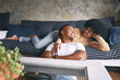 © peopleimages.com - Love, bonding and smile with couple on sofa for discussion, support and relax together. Happiness, loyalty and peace with African man and woman in living room of home for calm, connection and trust