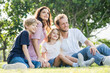 © Nopphon - Happy family parent children having picnic outdoor activity. Enjoy happiness moment summer playing together including father mother son and daughter relaxing in the morning sunrise.