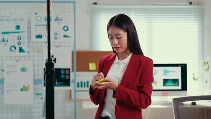 Aufkleber - Professional businesswoman wearing red jacket planning project strategy, writing and attaching sticky notes to whiteboard in modern corporate office setting