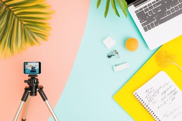 Poster - Vibrant Desk for Micro-Influencer Smartphone Tripod and Laptop on Colorful Surface - Creative Content Planning and Personal Branding in Digital Marketing