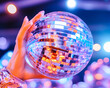 © bcendet - Woman holding disco ball, party lights background, nightlife entertainment