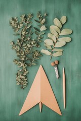 Wall Mural - Scandi Creative Workspace Minimalist Paper Airplane with Leafy Eucalyptus on Wooden Surface - Modern Educational Design and Imaginative Learning Tools for Creative Development