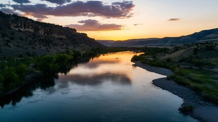 Canvas Print - Tranquil Sunset Over a Serene River Surrounded by Majestic Mountains in Golden Hour : Generative AI