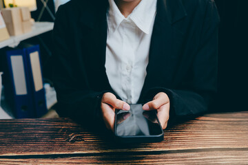 Poster - Person in Business Attire Using Smartphone on Wooden Table Surface, business concept