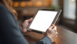 © 2April - Business woman using digital tablet with white screen mockup in cozy cafe for remote work and online shopping